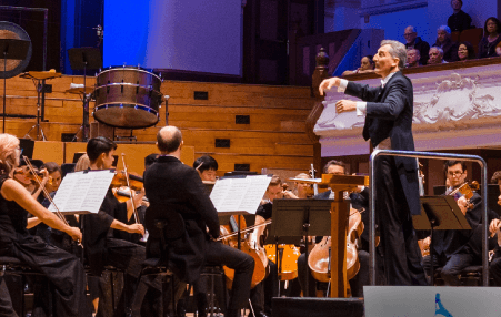 a conductor and an orchestra